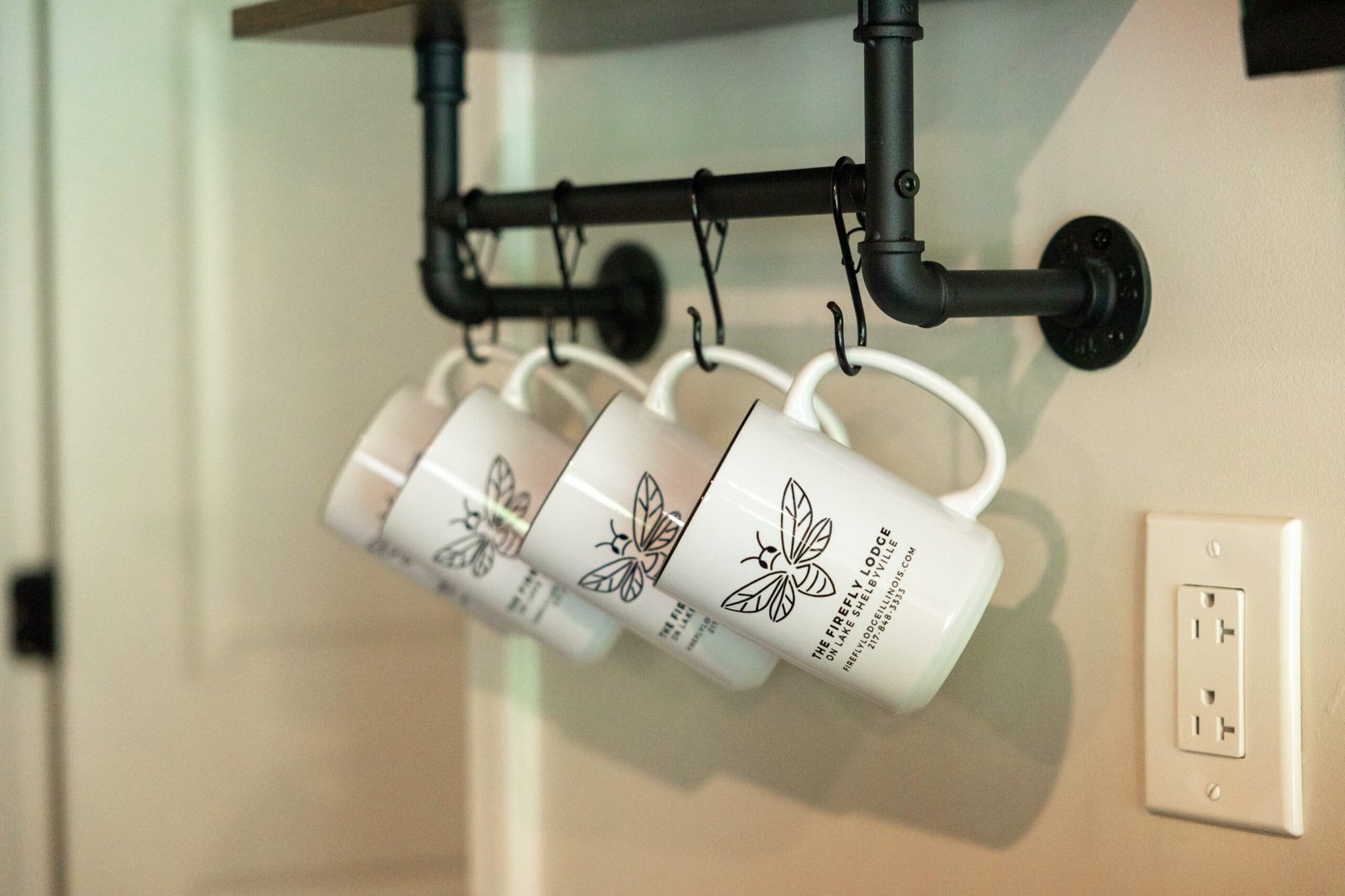 Branded mugs at the coffee bar