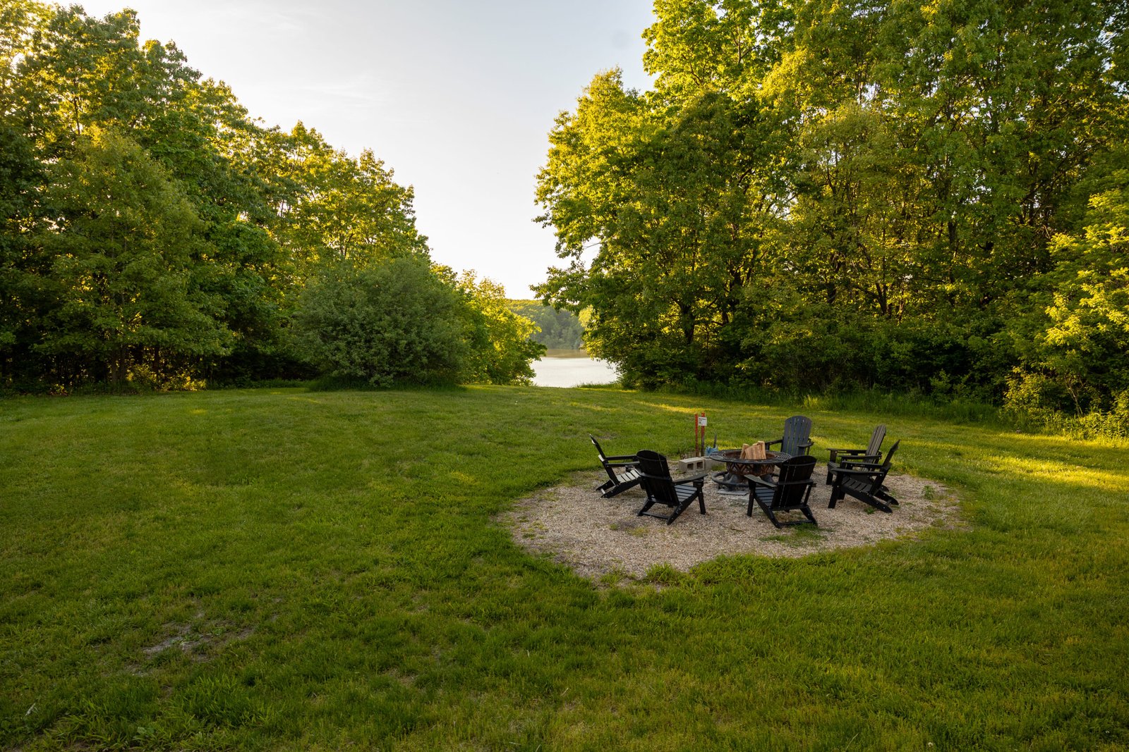 Fire pit at sunset with Adirondack chairs